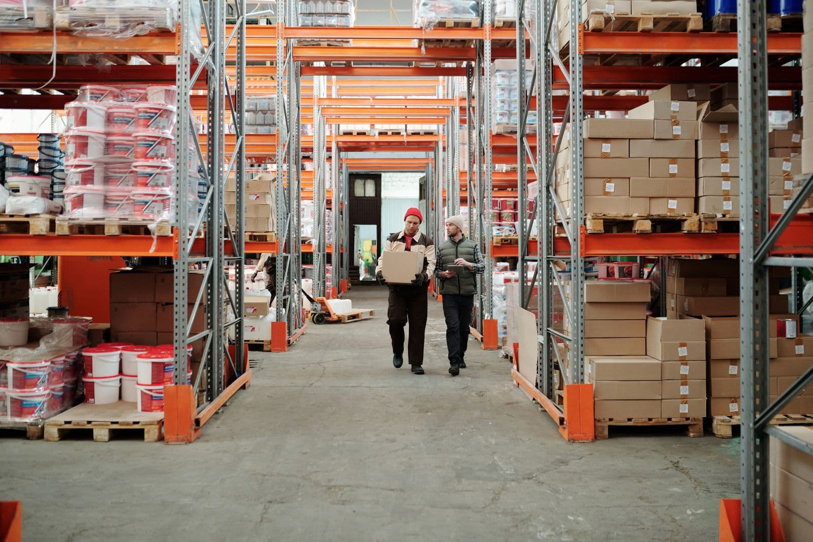 Stallionex warehouse staff sorting parcels between storage racks